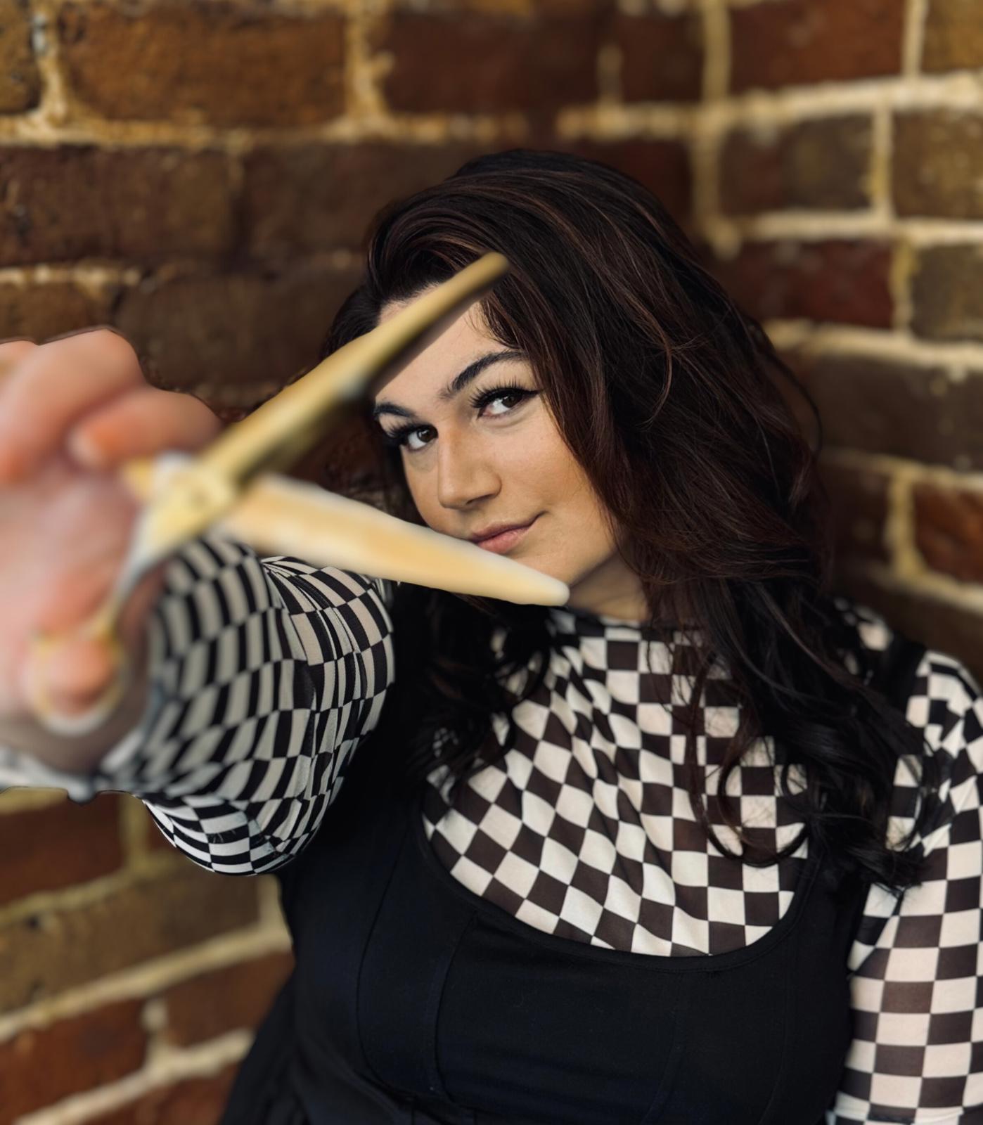 Maggie Loven, colorist at Velvet Color Co., holding shears